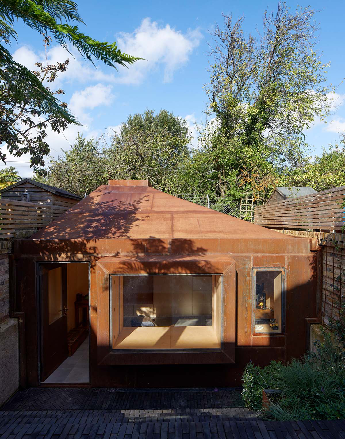 RISE Design Studio built sunken garden studio with rusted steel to provide a hidden place to escape