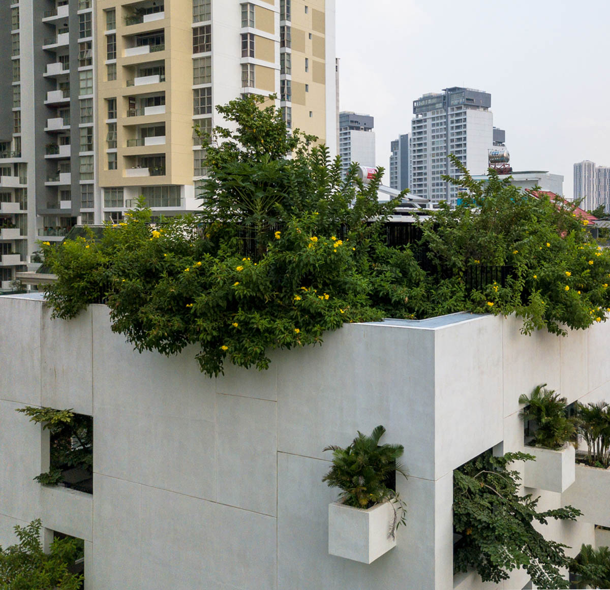 MIA Design Studio compensates the lack of green spaces of Vietnam with planted pop-up balconies