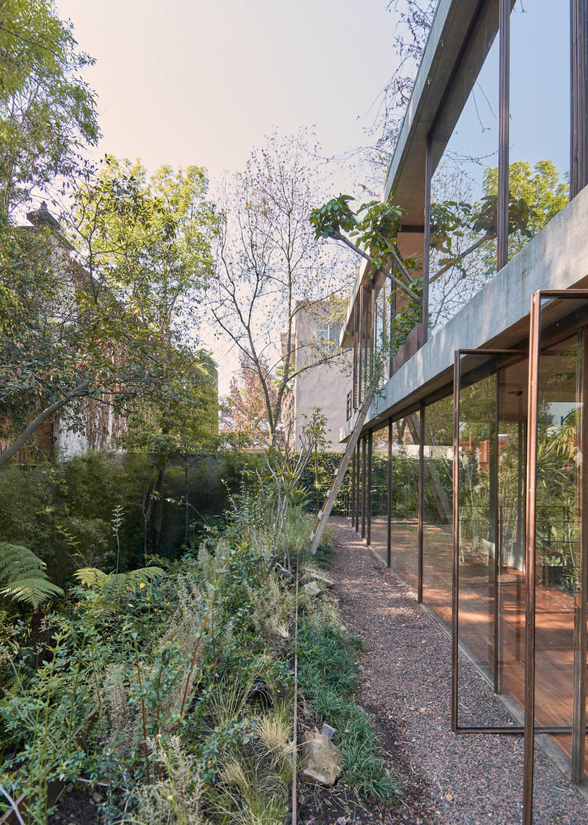 Triangular and faceted green terraces provide generous open spaces for this residence by Vertebral
