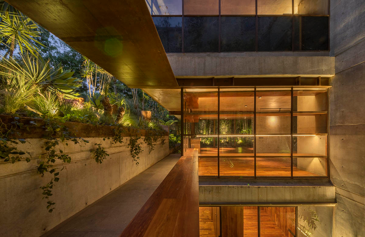 Triangular and faceted green terraces provide generous open spaces for this residence by Vertebral