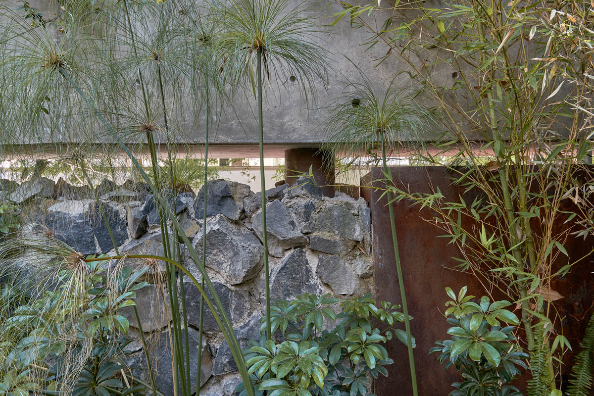 Triangular and faceted green terraces provide generous open spaces for this residence by Vertebral