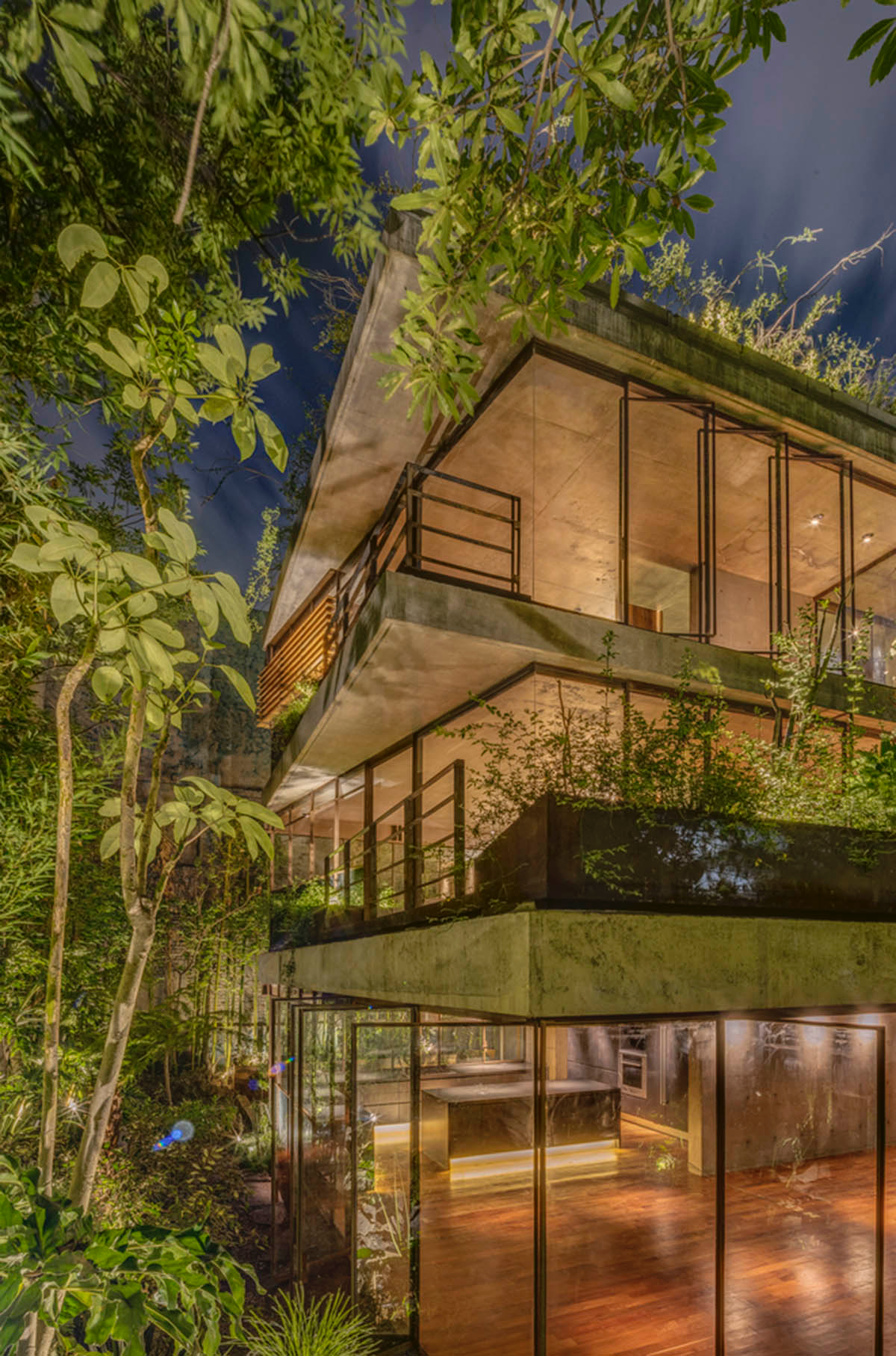 Triangular and faceted green terraces provide generous open spaces for this residence by Vertebral