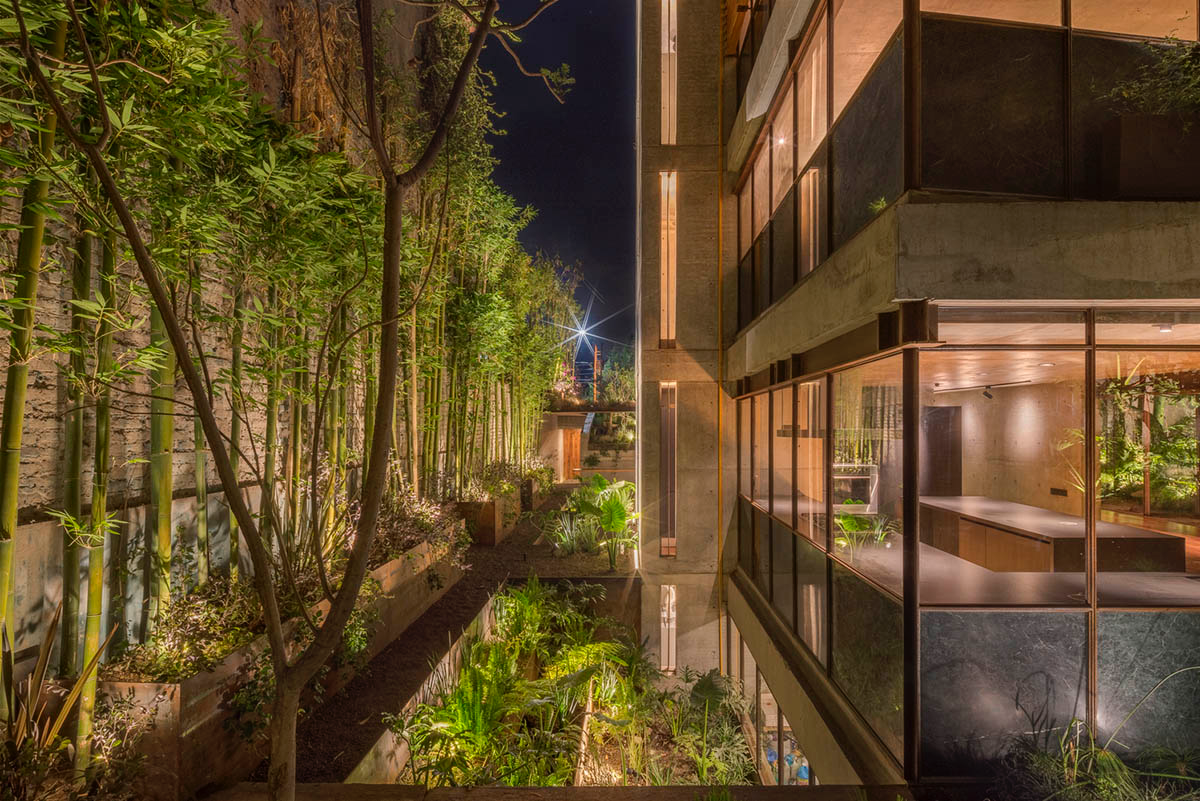 Triangular and faceted green terraces provide generous open spaces for this residence by Vertebral