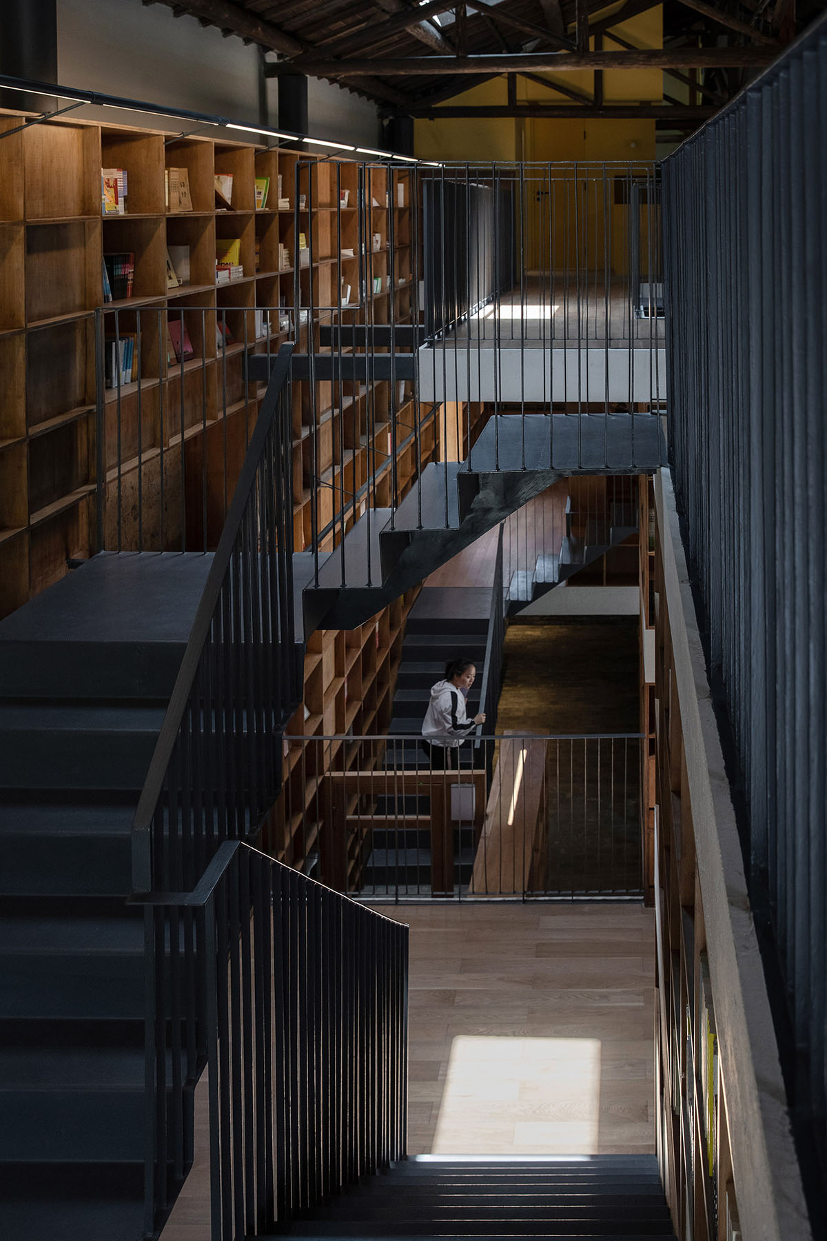 Atelier tao+c converts old building into capsule hotel with corrugated polycarbonate panels in China