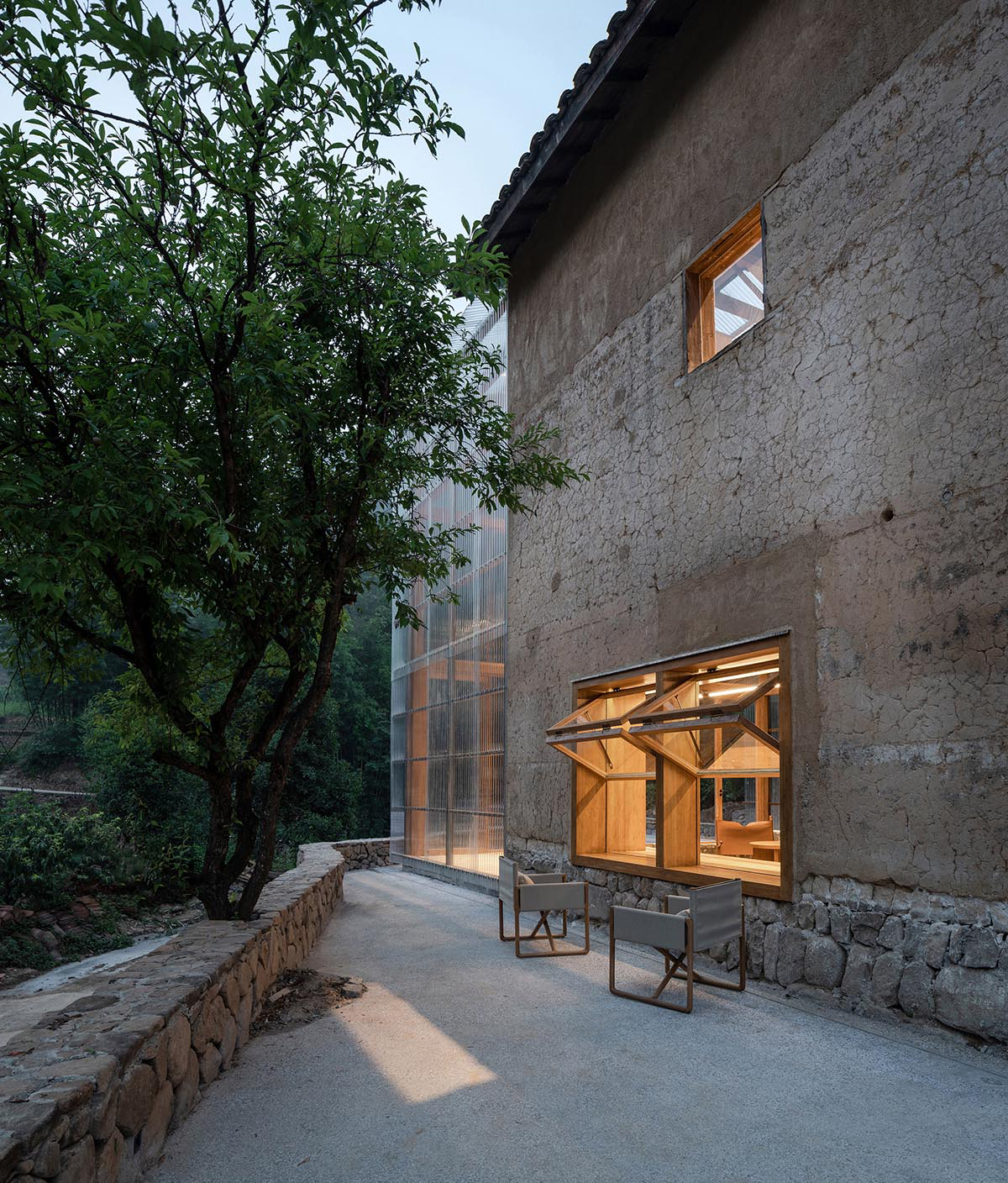 Atelier tao+c converts old building into capsule hotel with corrugated polycarbonate panels in China