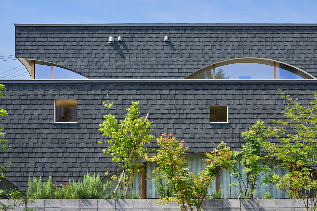 A dental clinic and daycare center are hidden under arches in Japan by Takeru Shoji Architects