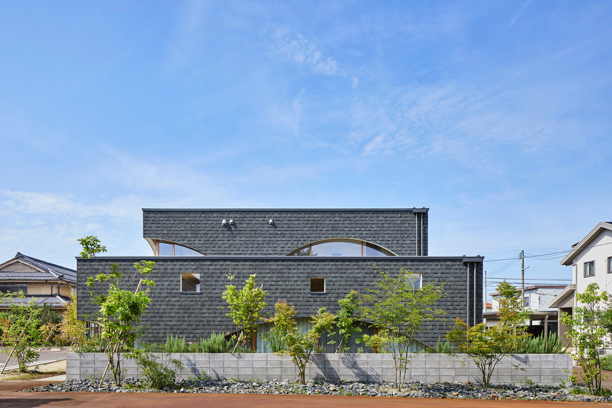 A dental clinic and daycare center are hidden under arches in Japan by Takeru Shoji Architects