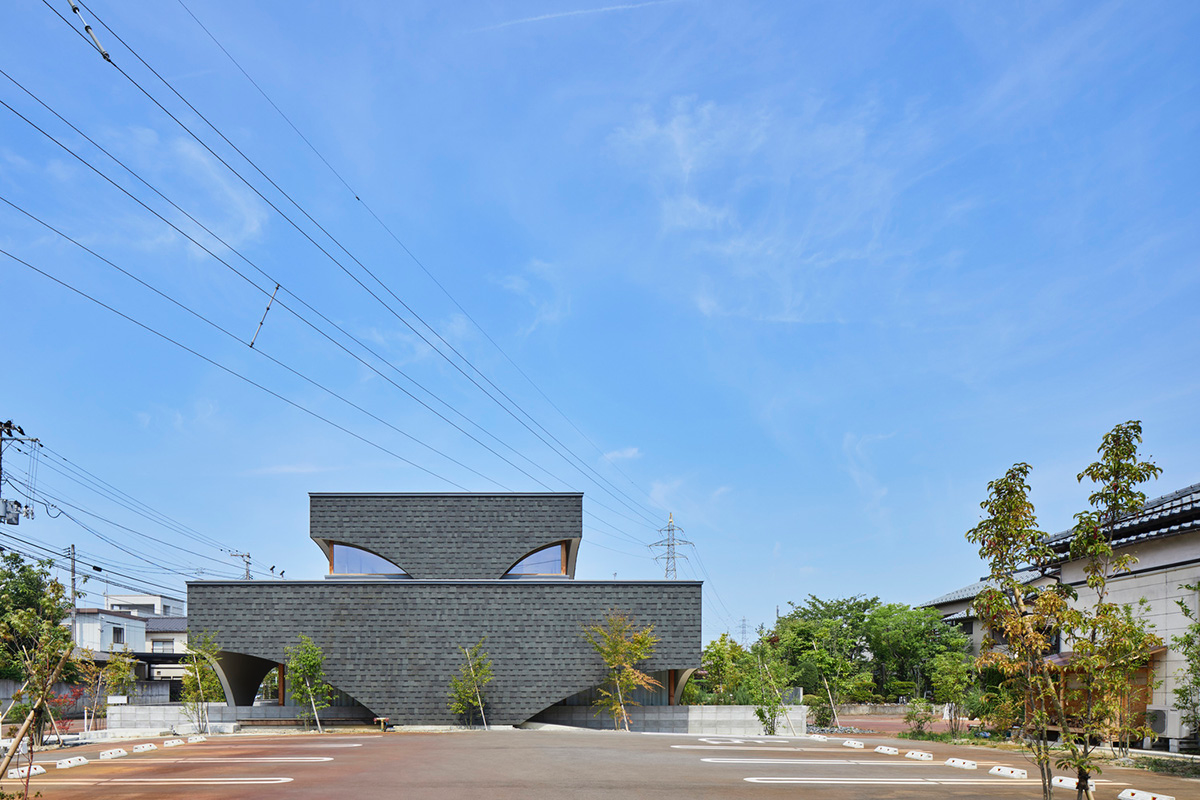 A dental clinic and daycare center are hidden under arches in Japan by Takeru Shoji Architects