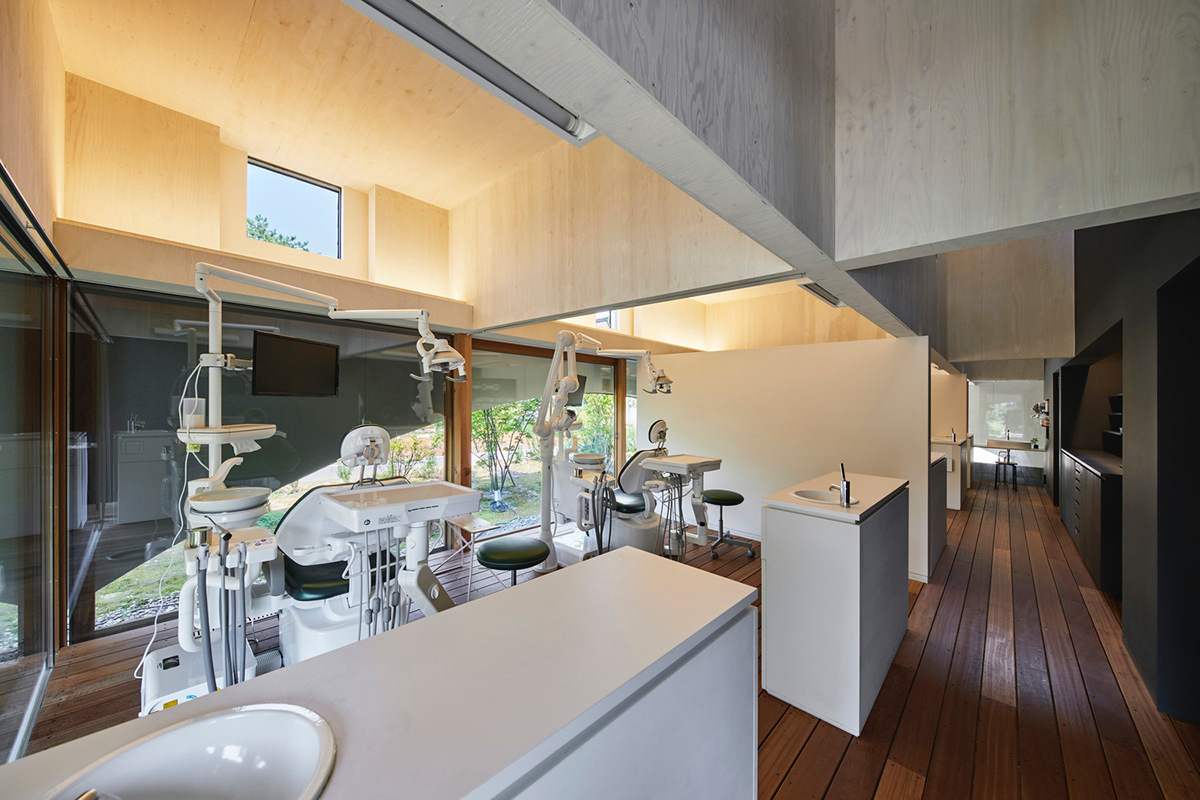 A dental clinic and daycare center are hidden under arches in Japan by Takeru Shoji Architects
