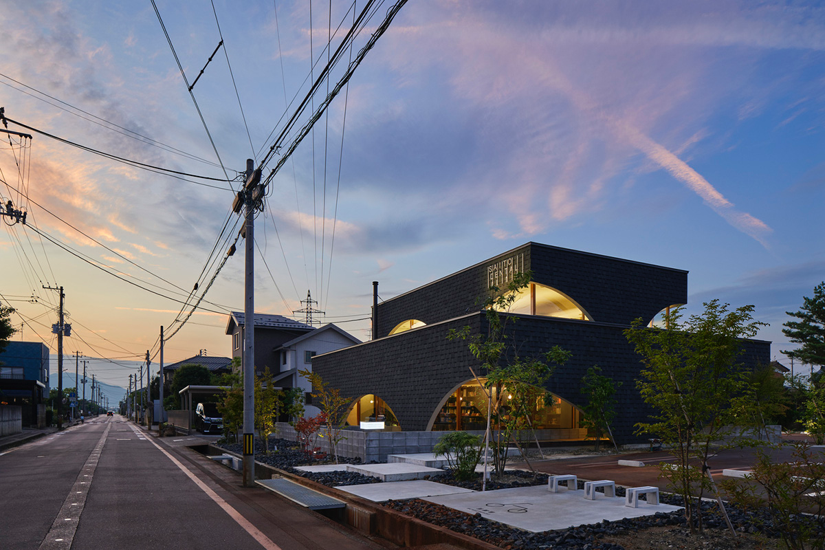 A dental clinic and daycare center are hidden under arches in Japan by Takeru Shoji Architects