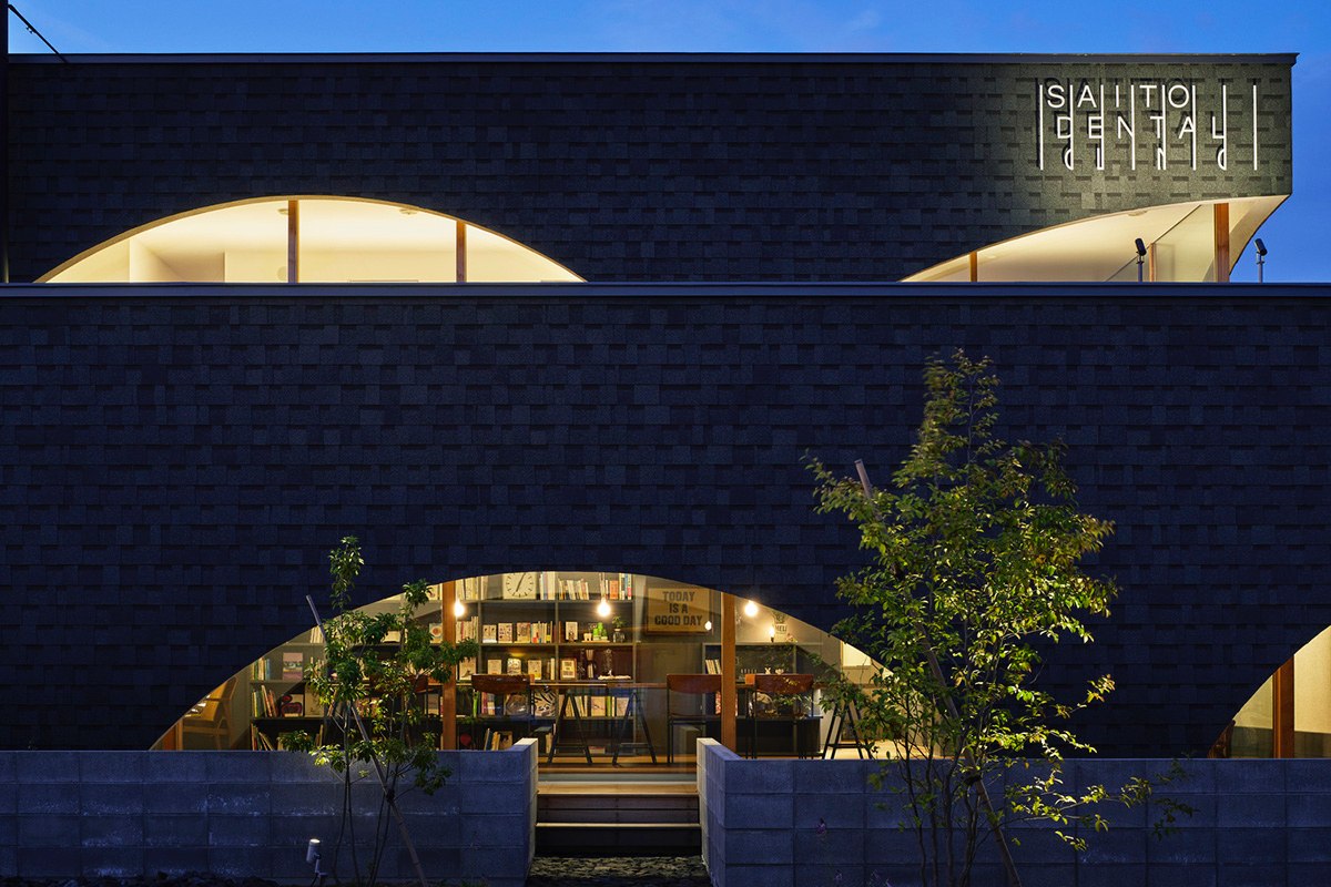 A dental clinic and daycare center are hidden under arches in Japan by Takeru Shoji Architects