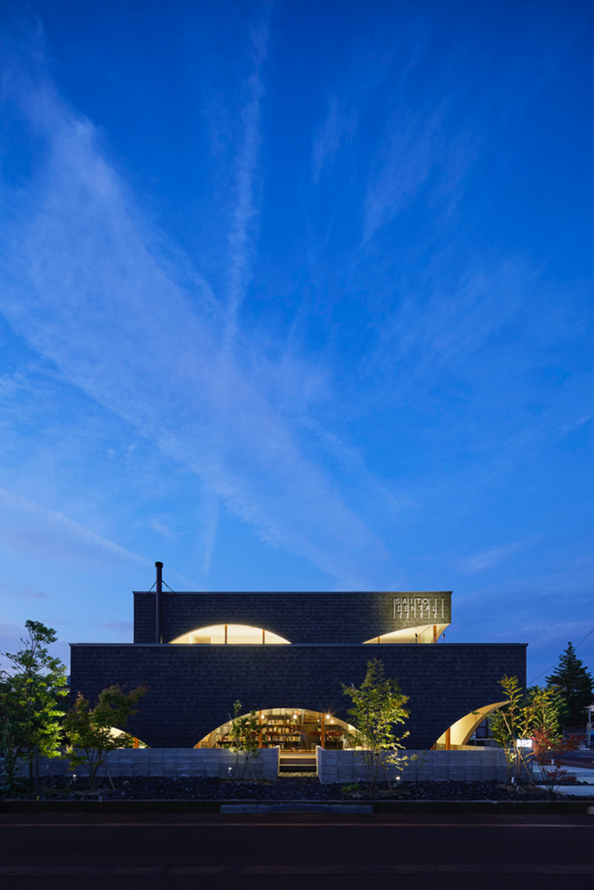 A dental clinic and daycare center are hidden under arches in Japan by Takeru Shoji Architects