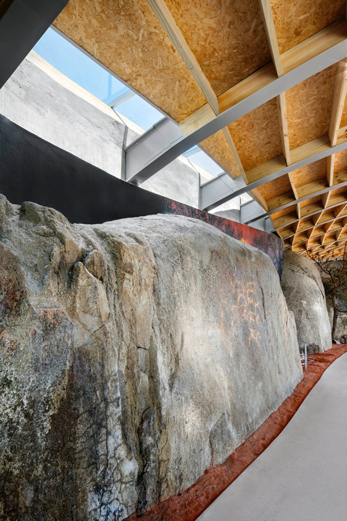 KLG Architects completes heritage center with undulating roof that acts as a small shelter