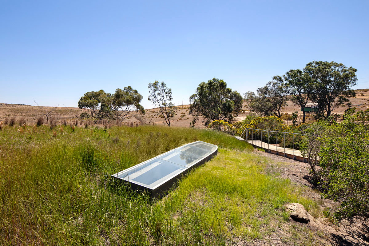 KLG Architects completes heritage center with undulating roof that acts as a small shelter
