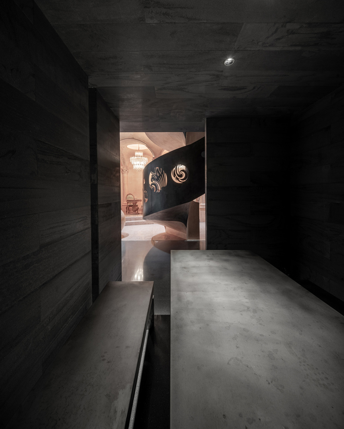 Pink elements and dark colors create sharp contrast in the interiors of restaurant and showroom