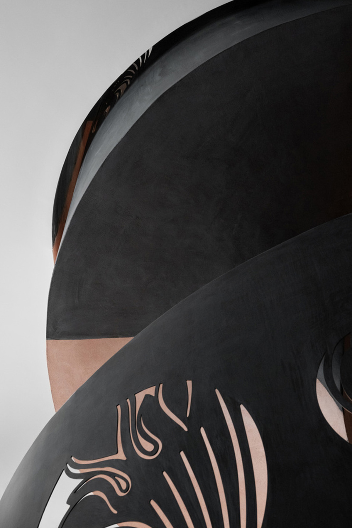 Pink elements and dark colors create sharp contrast in the interiors of restaurant and showroom