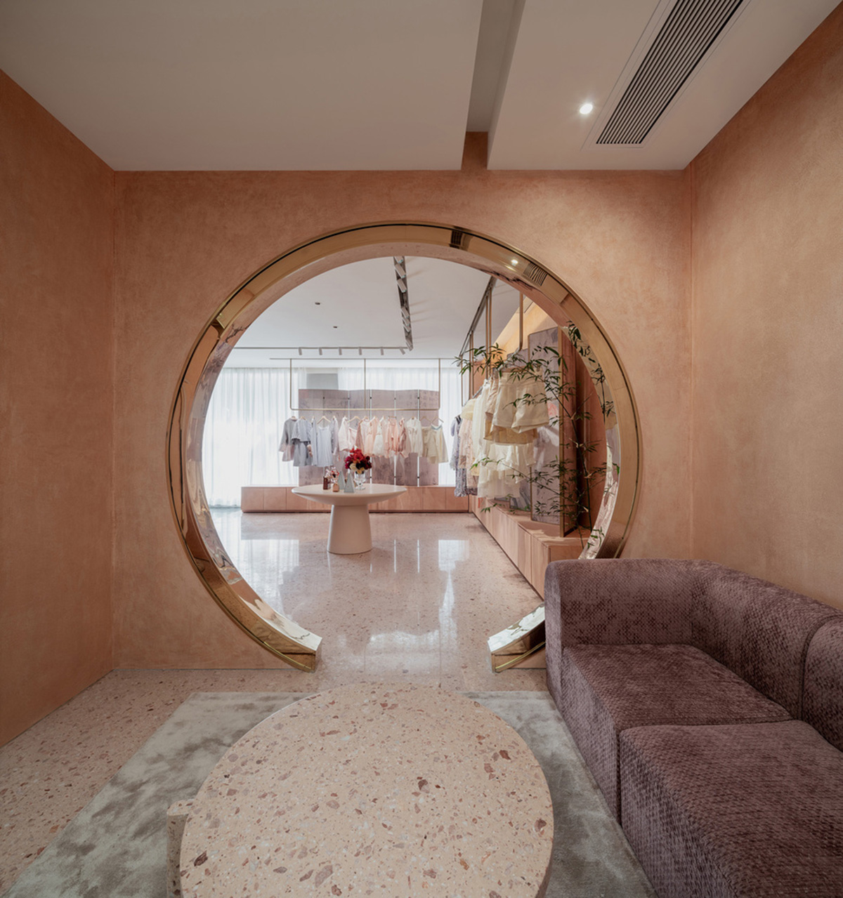 Pink elements and dark colors create sharp contrast in the interiors of restaurant and showroom