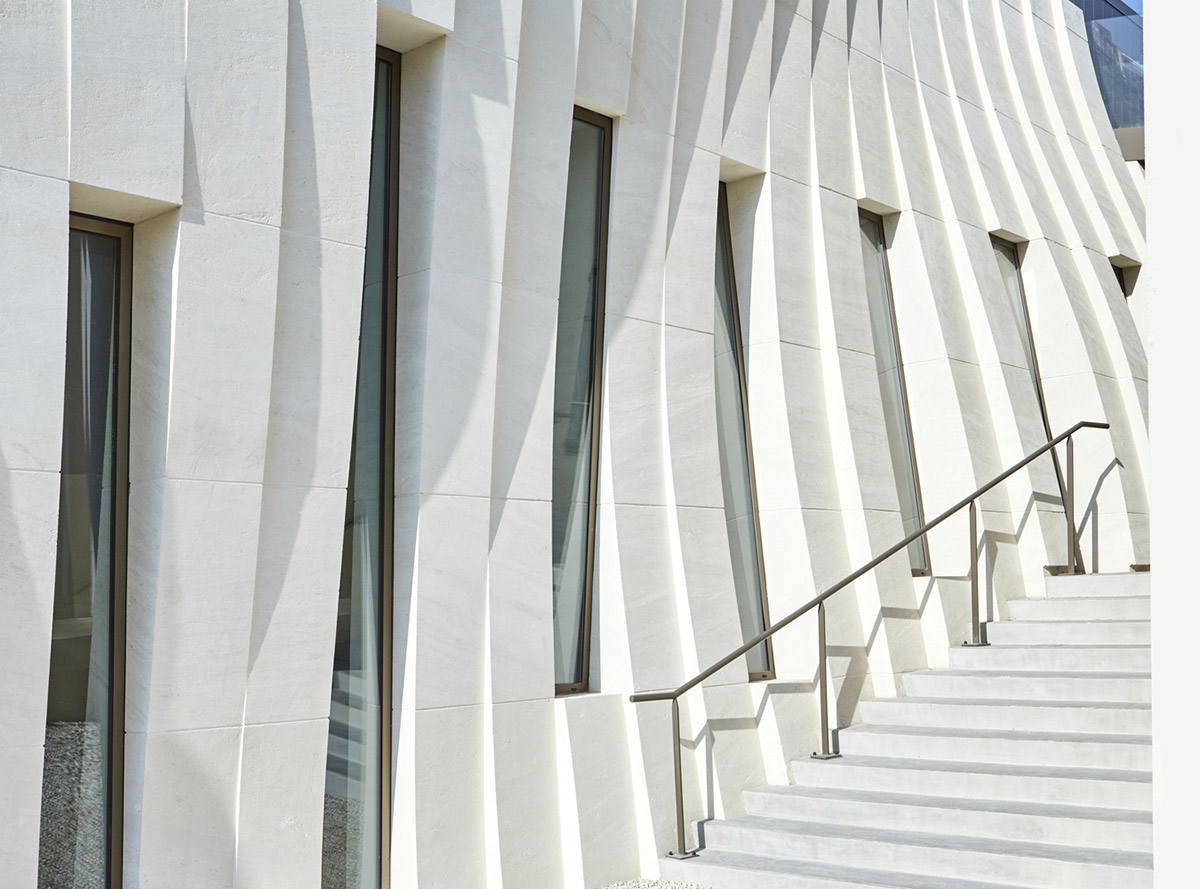 Curving stone solid walls form this winery and guide visitors for winemaking process in France