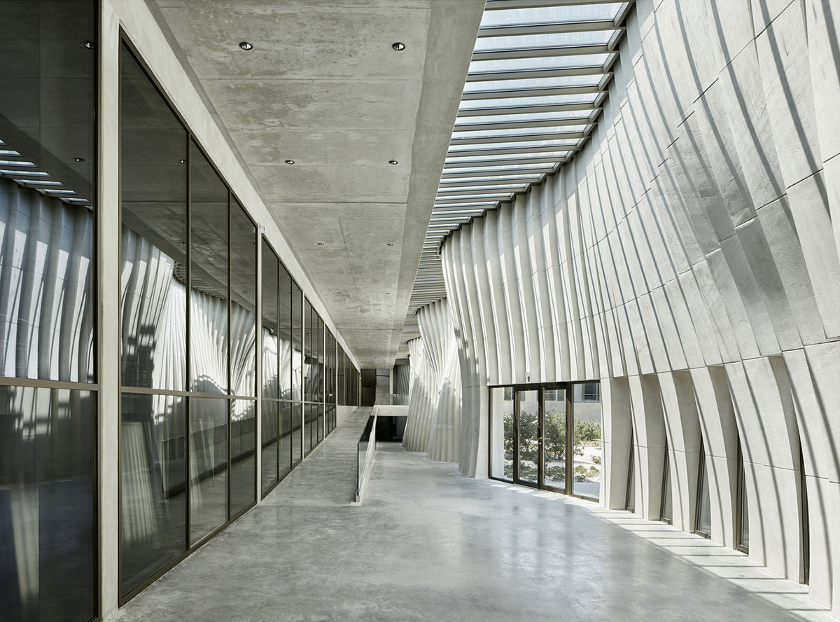 Curving stone solid walls form this winery and guide visitors for winemaking process in France