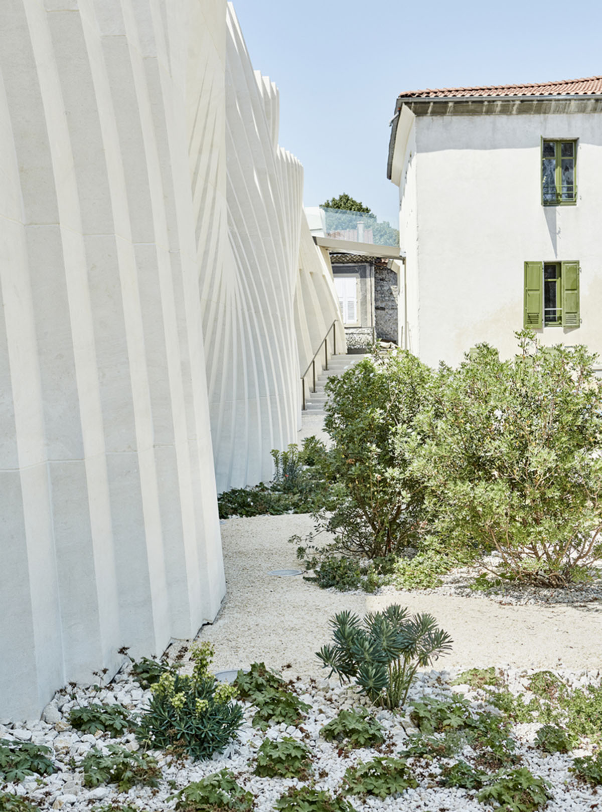 Curving stone solid walls form this winery and guide visitors for winemaking process in France