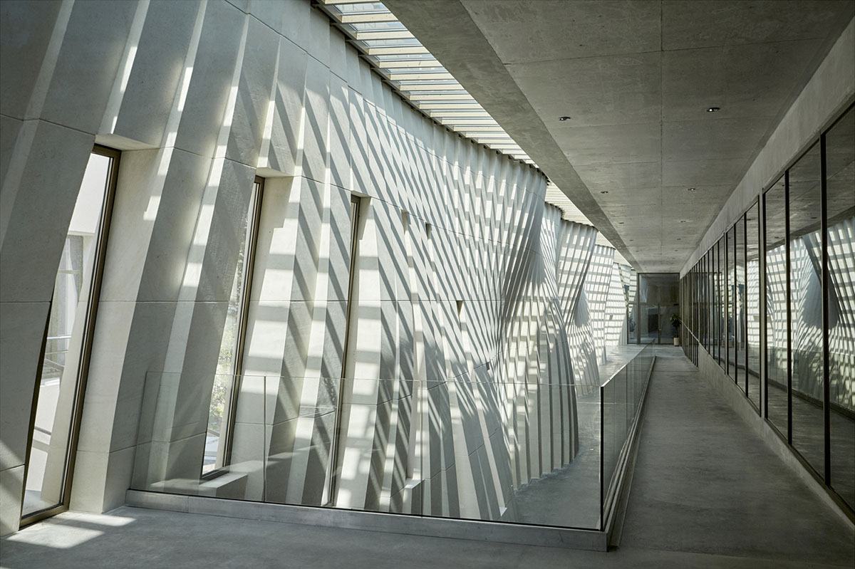 Curving stone solid walls form this winery and guide visitors for winemaking process in France