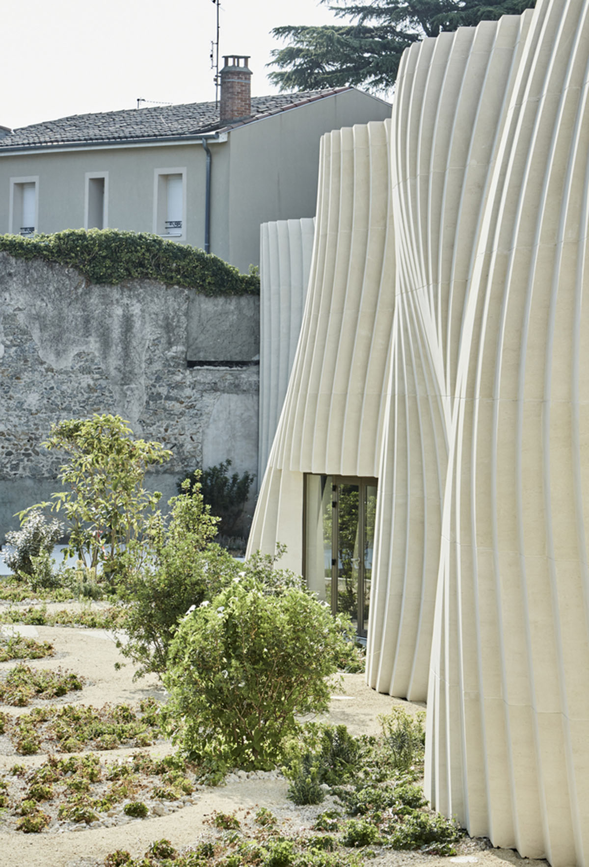 Curving stone solid walls form this winery and guide visitors for winemaking process in France