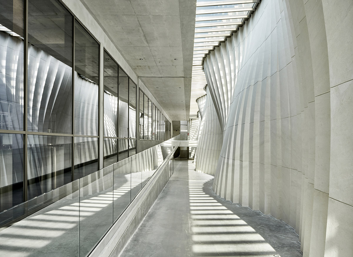 Curving stone solid walls form this winery and guide visitors for winemaking process in France