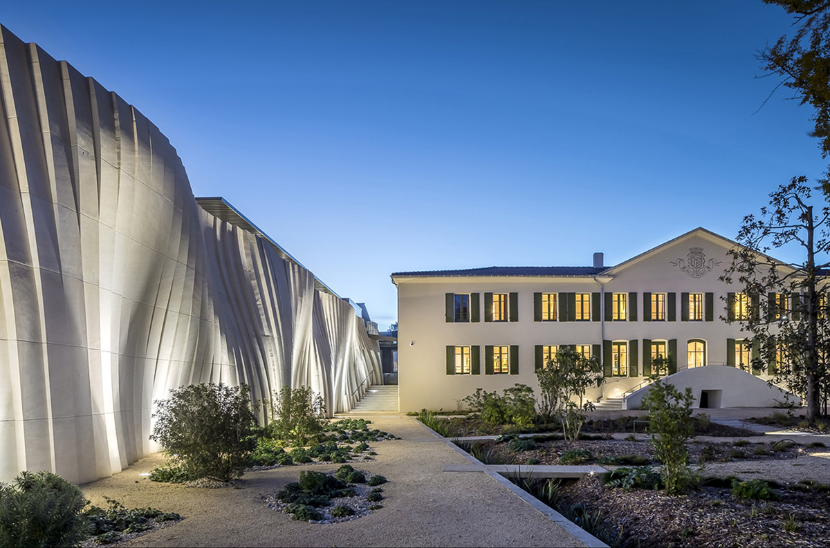 Curving stone solid walls form this winery and guide visitors for winemaking process in France
