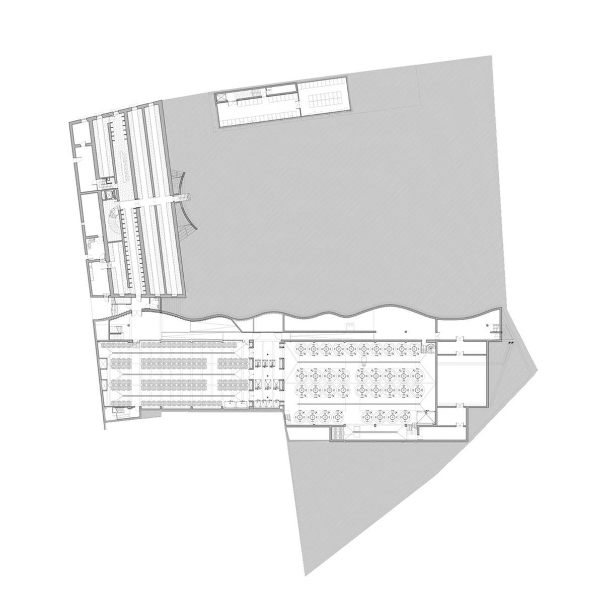 Curving stone solid walls form this winery and guide visitors for winemaking process in France