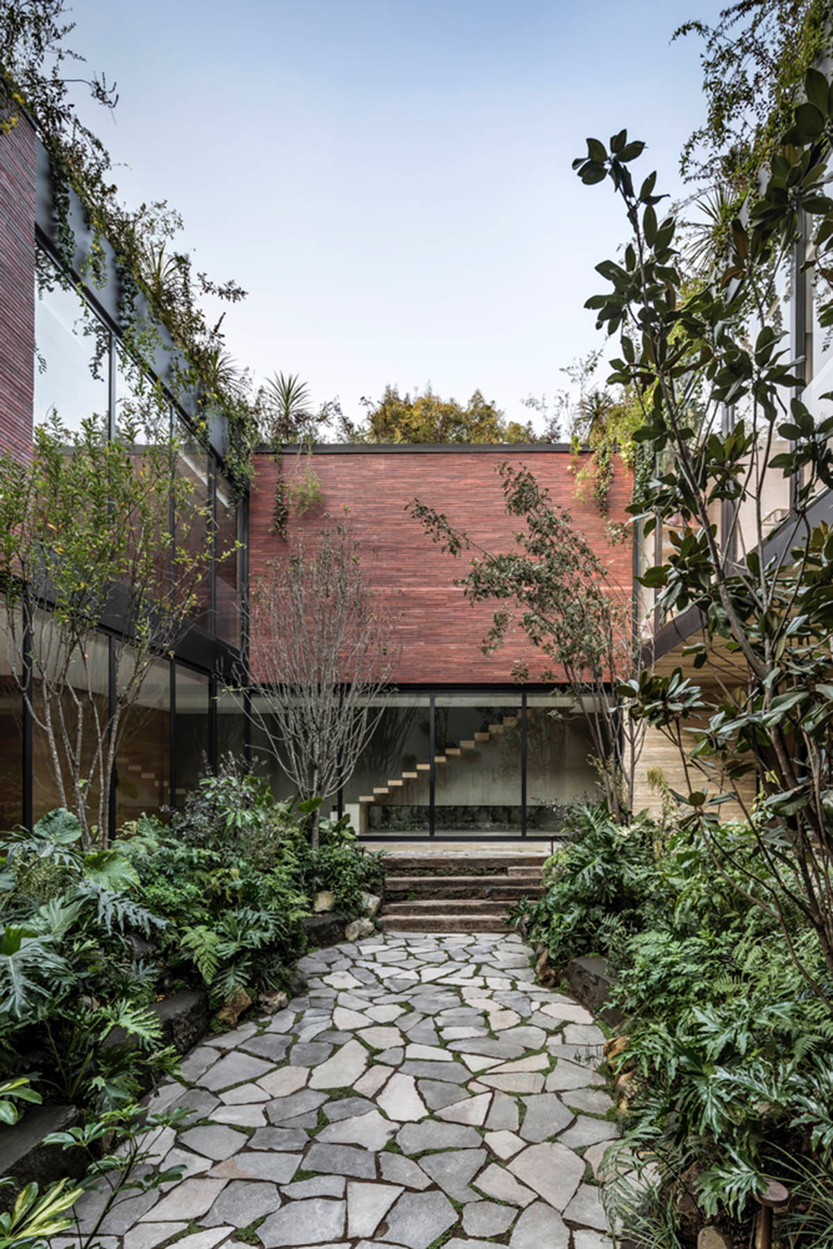 ESRAWE designs house by using red brick pavilion-like volumes in Mexico City