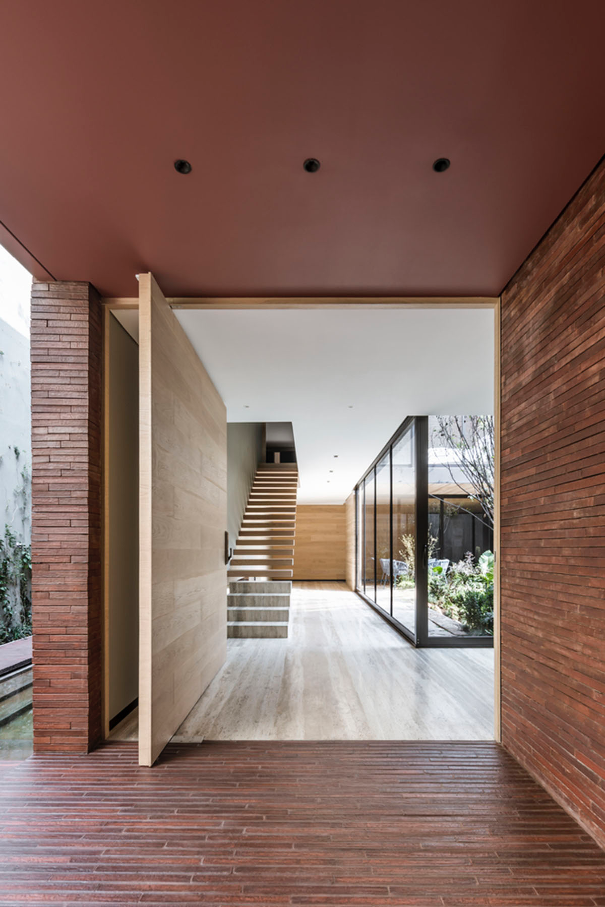 ESRAWE designs house by using red brick pavilion-like volumes in Mexico City