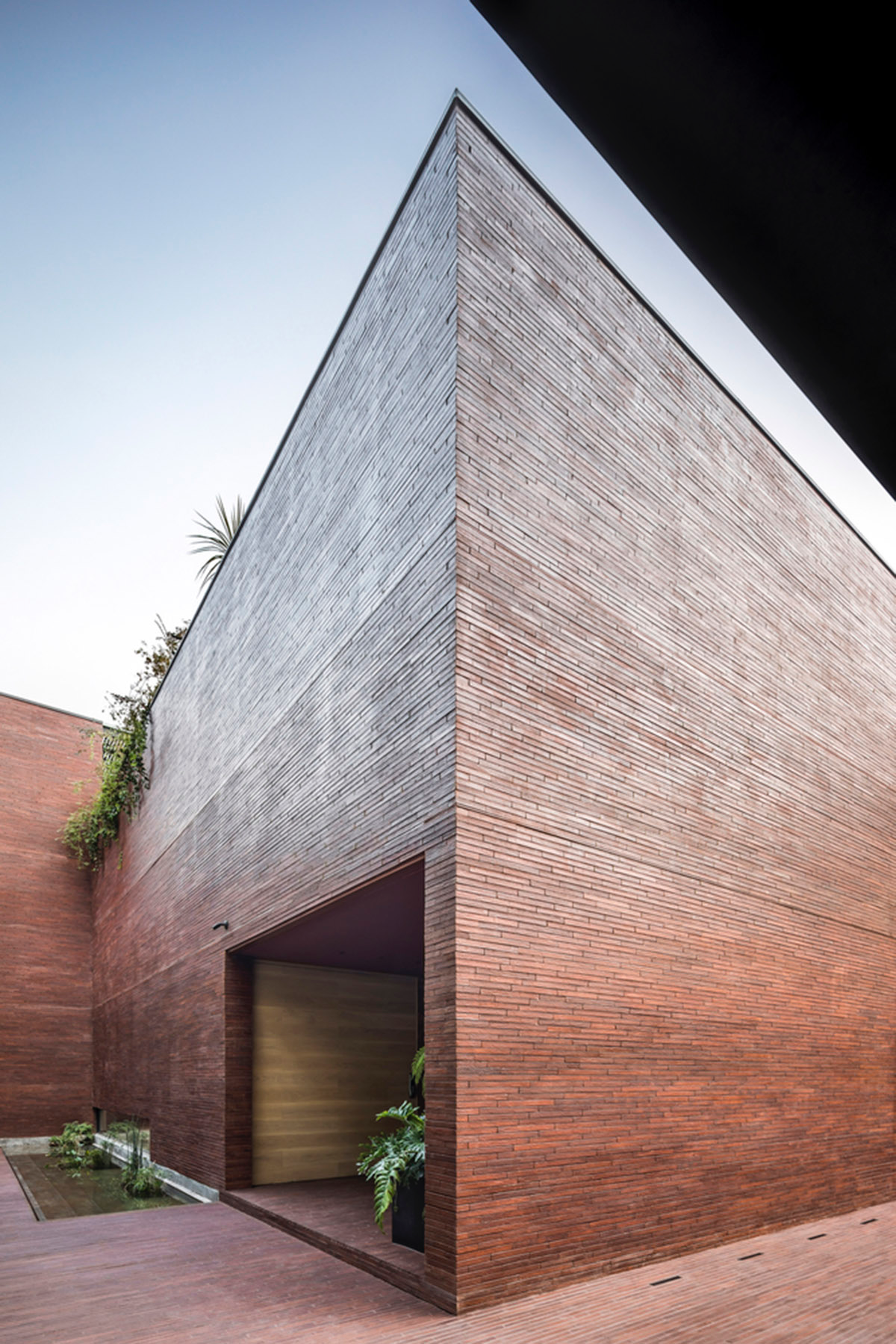 ESRAWE designs house by using red brick pavilion-like volumes in Mexico City