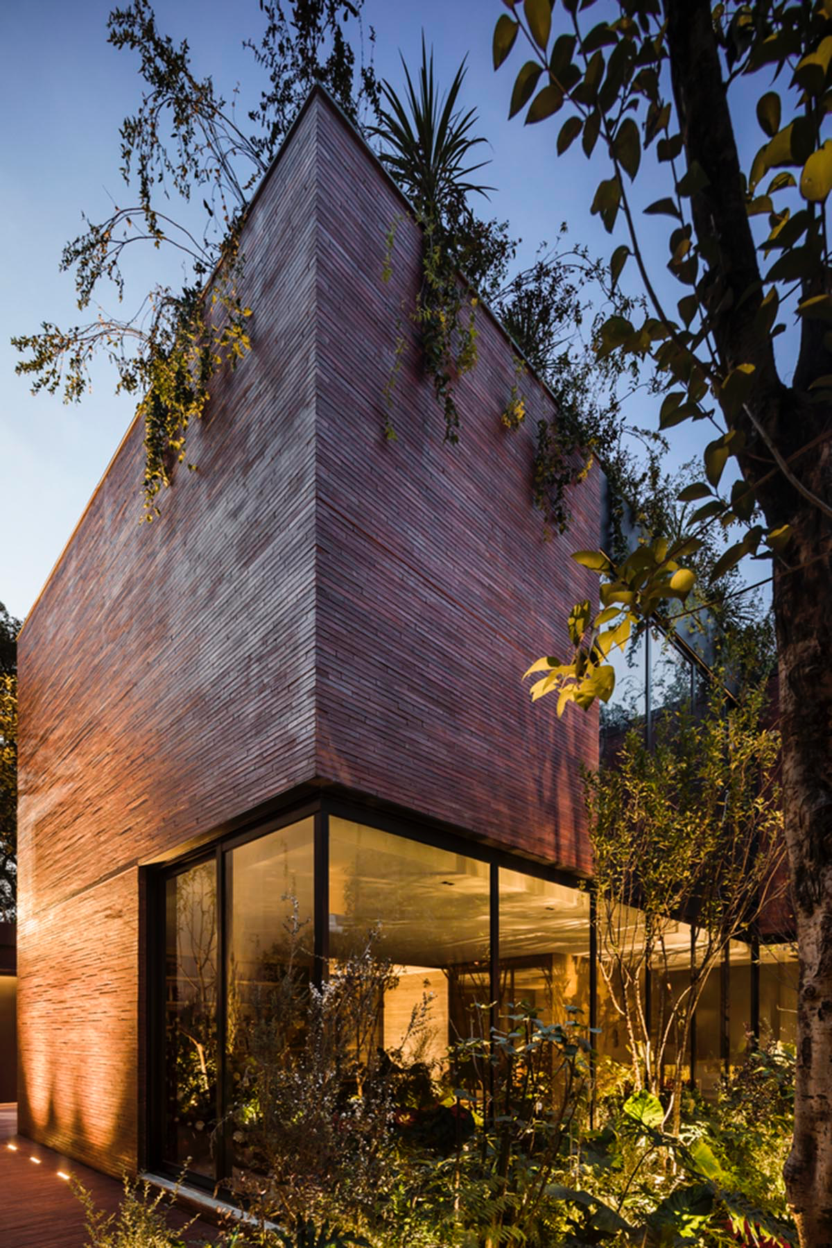 ESRAWE designs house by using red brick pavilion-like volumes in Mexico City
