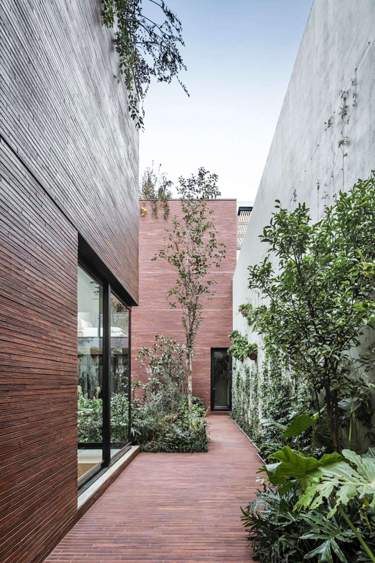 ESRAWE designs house by using red brick pavilion-like volumes in Mexico City