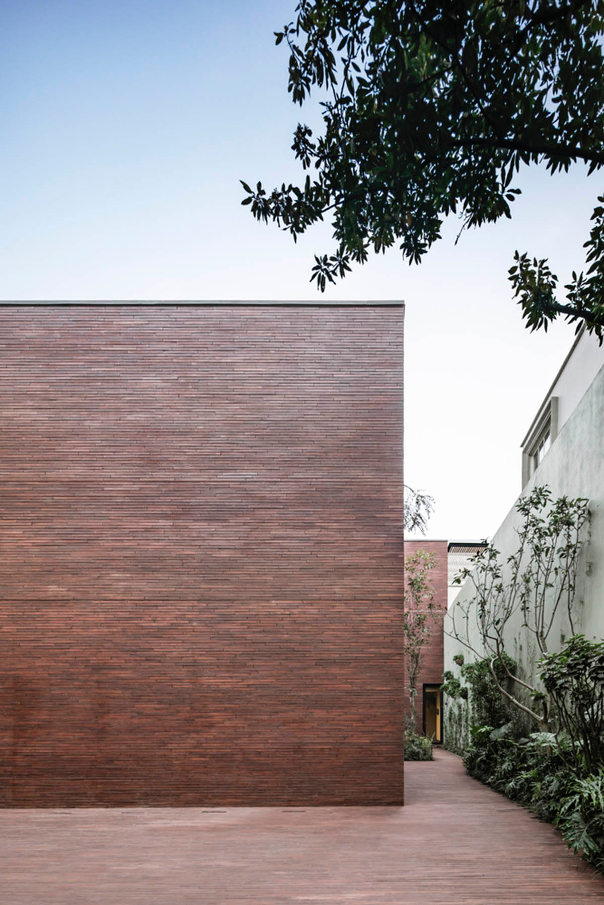 ESRAWE designs house by using red brick pavilion-like volumes in Mexico City