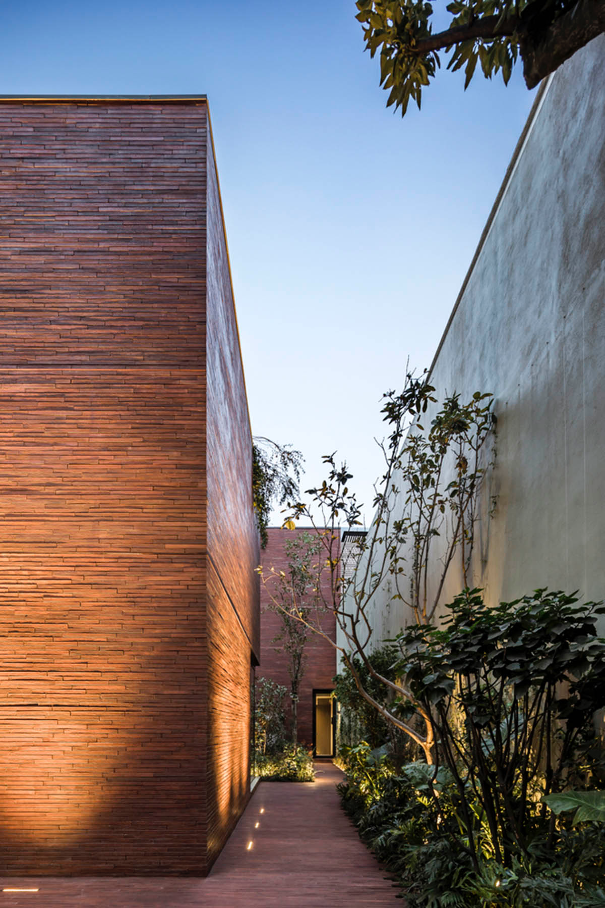 ESRAWE designs house by using red brick pavilion-like volumes in Mexico City