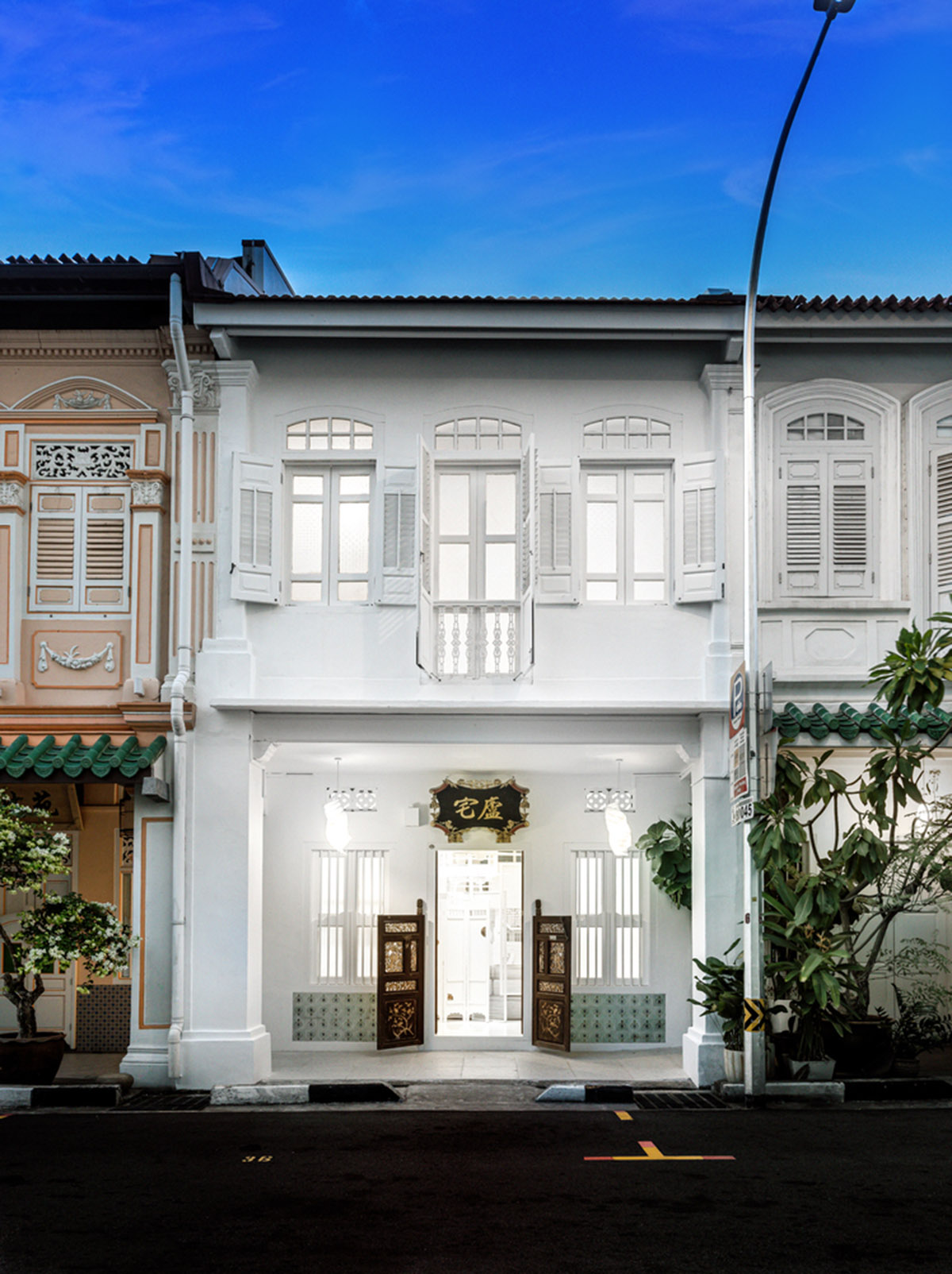 Ministry of Design transforms old dwelling in Singapore into co-living house with all-white interiors