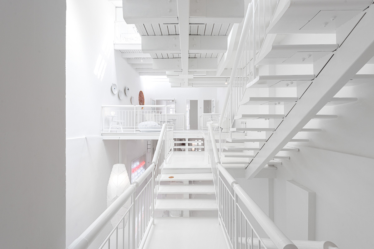 Ministry of Design transforms old dwelling in Singapore into co-living house with all-white interiors