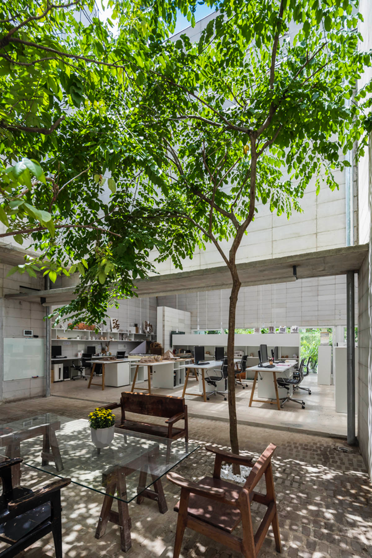 An office in Vietnam protects its own micro-climate with continuous spaces and internal courtyards