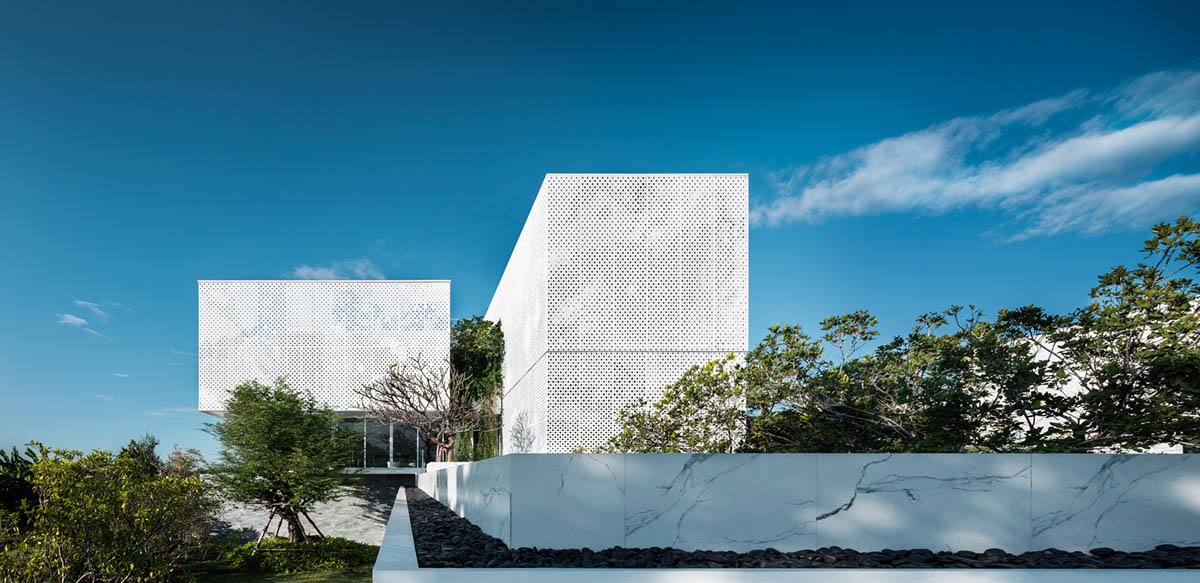 AAd built self-sustainable residence with perforated facade and steel rods in Thailand