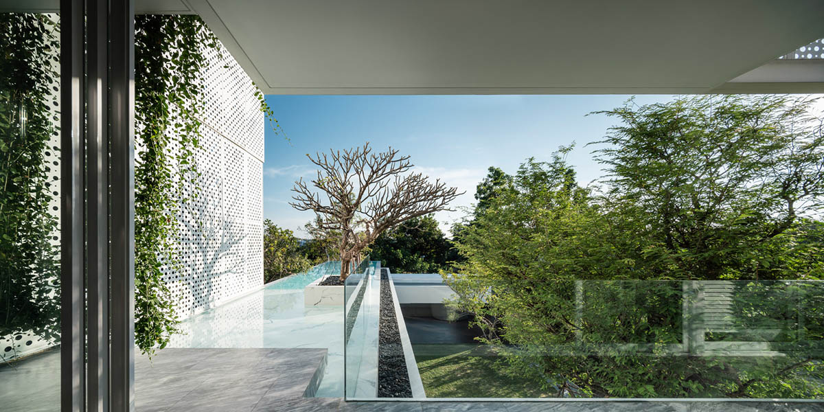 AAd built self-sustainable residence with perforated facade and steel rods in Thailand