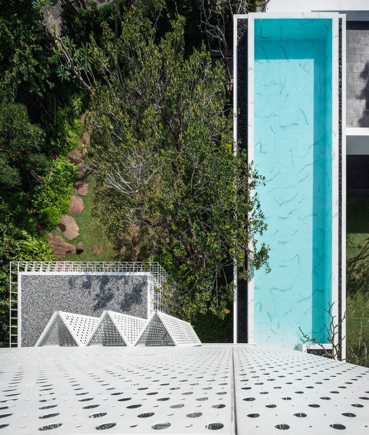 AAd built self-sustainable residence with perforated facade and steel rods in Thailand