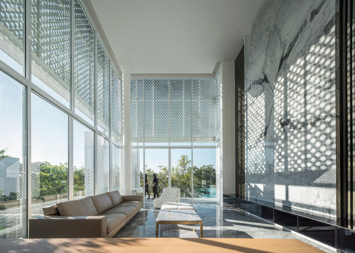 AAd built self-sustainable residence with perforated facade and steel rods in Thailand