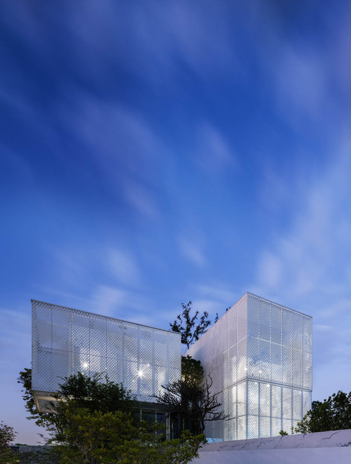 AAd built self-sustainable residence with perforated facade and steel rods in Thailand