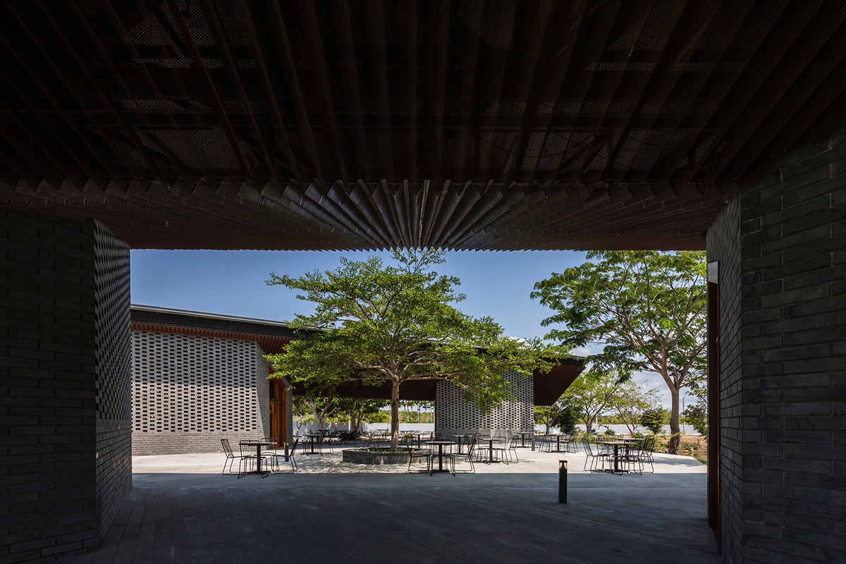 Hexagonal pavilions are hidden under V-shaped roofs that look like a pair of bird wings in Vietnam