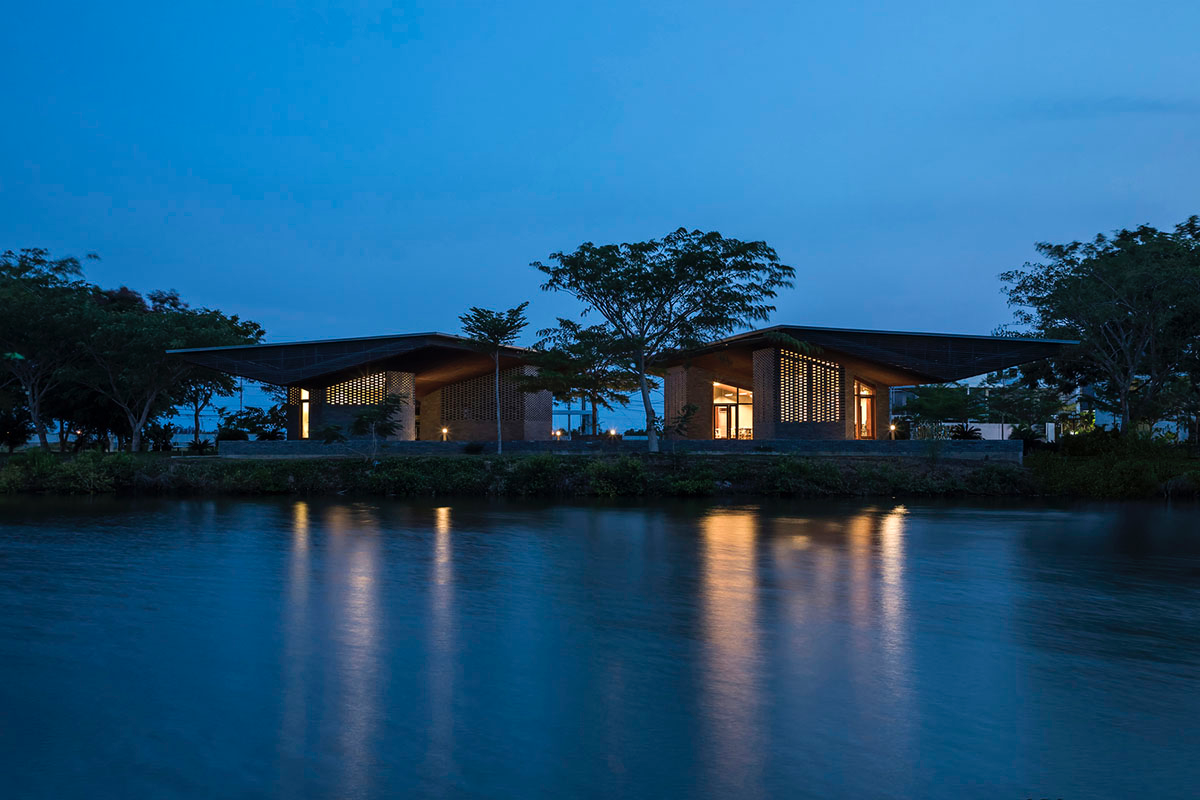 Hexagonal pavilions are hidden under V-shaped roofs that look like a pair of bird wings in Vietnam