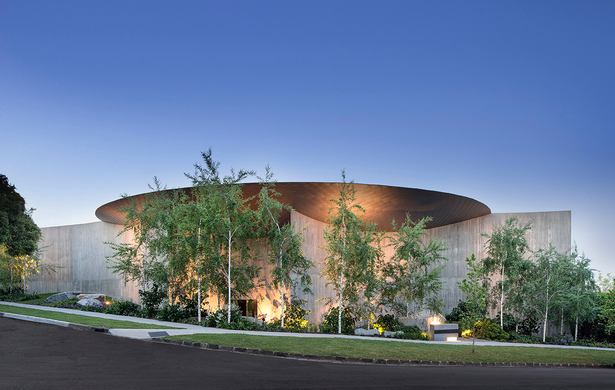 Wood Marsh built sculptural Towers Road House that features disc-shaped zinc roof in Toorak
