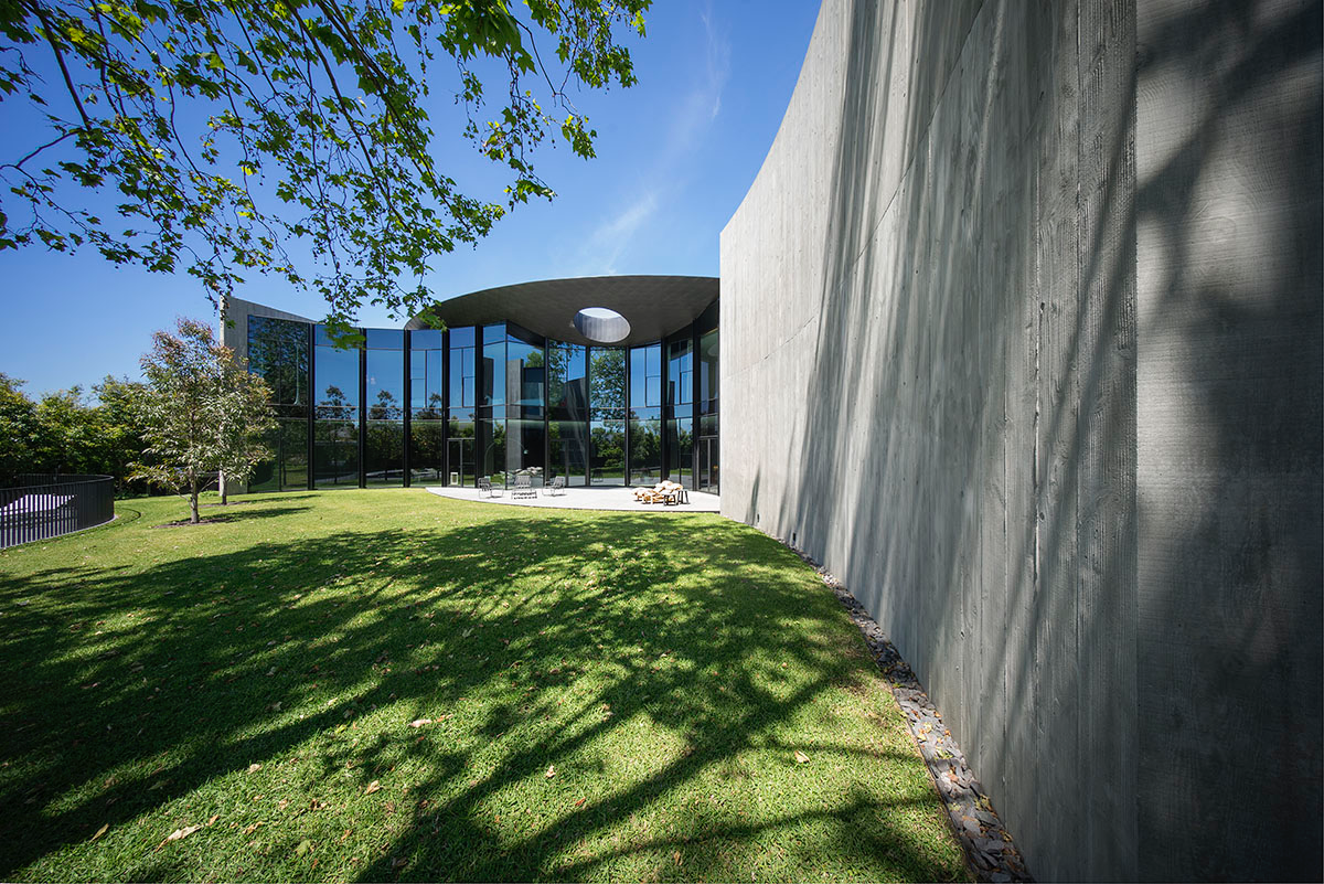 Wood Marsh built sculptural Towers Road House that features disc-shaped zinc roof in Toorak