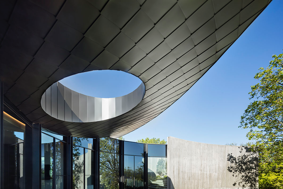 Wood Marsh built sculptural Towers Road House that features disc-shaped zinc roof in Toorak