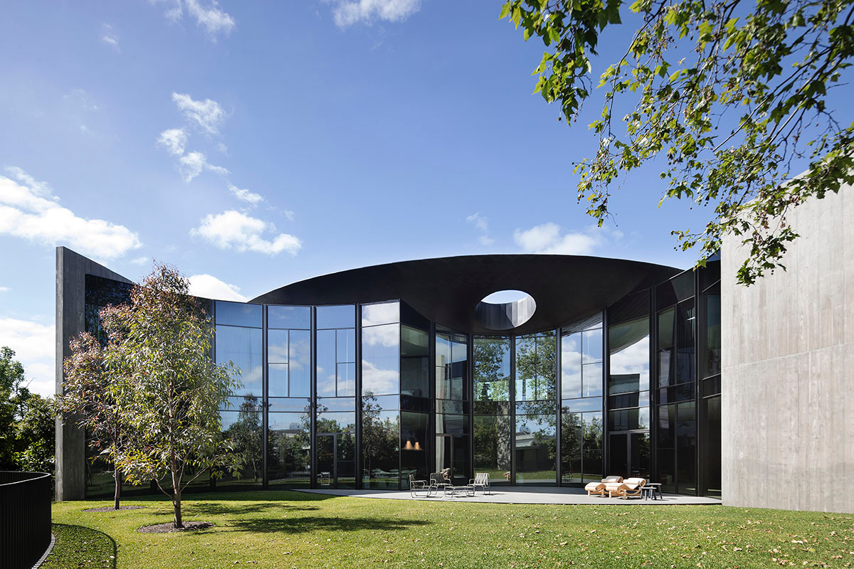 Wood Marsh built sculptural Towers Road House that features disc-shaped zinc roof in Toorak
